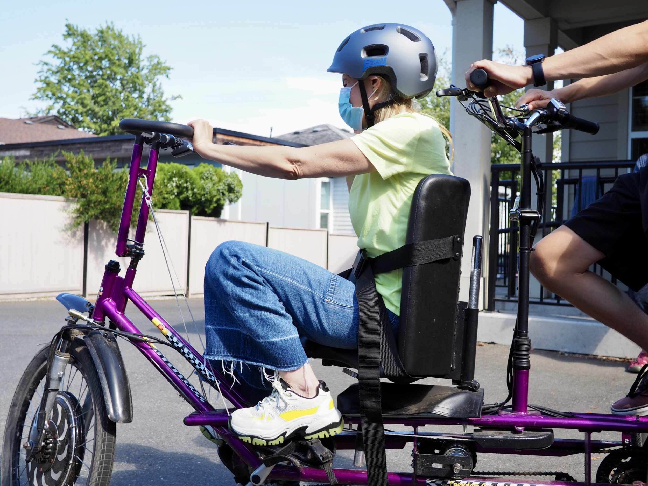 having fun riding the purple bike